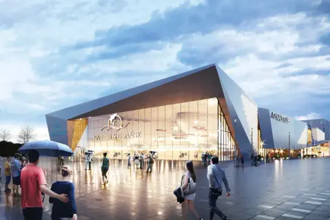 Nowoczesny budynek oceanarium Gdańsk z napisem "Nautilus Gdańsk" i logo delfina. Ludzie spacerują po placu przed budynkiem.