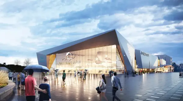 Nowoczesny budynek oceanarium Gdańsk z napisem "Nautilus Gdańsk" i logo delfina. Ludzie spacerują po placu przed budynkiem.