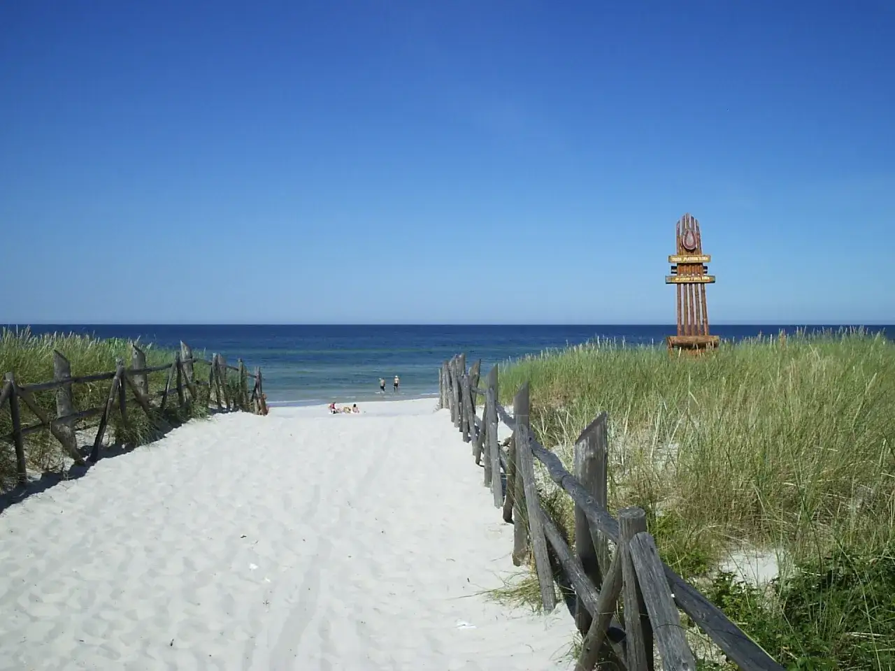 Piękna plaża w Lubiatowie z drewnianym drogowskazem. Atrakcje czekają nad morzem!